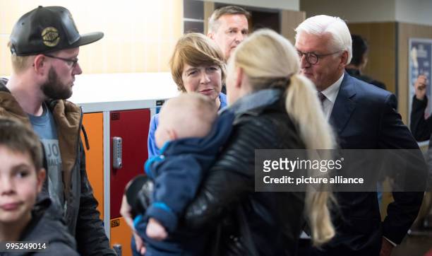 German president Frank-Walter Steinmeier and his wife Elke Buedenbender wait in line at a polling station with other voters in order to cast their...
