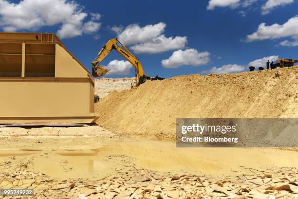 An excavator digs for sand at the Black Mountain Sand LLC Vest Mine in Winkler County, Texas, U.S., on Tuesday, June 19, 2018. In the West Texas...