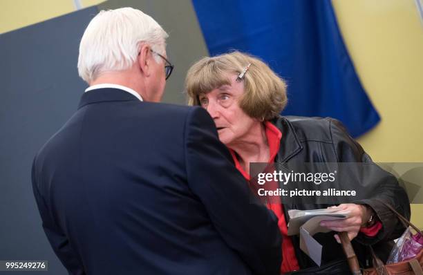 German president Frank-Walter Steinmeier is approached by an elderly woman at the polling station after casting his vote for the Federal Election...