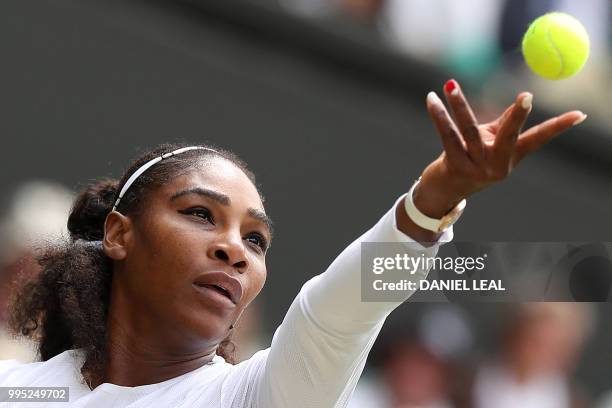 Player Serena Williams returns against Italy's Camila Giorgi during their women's singles quarter-final match on the eighth day of the 2018 Wimbledon...