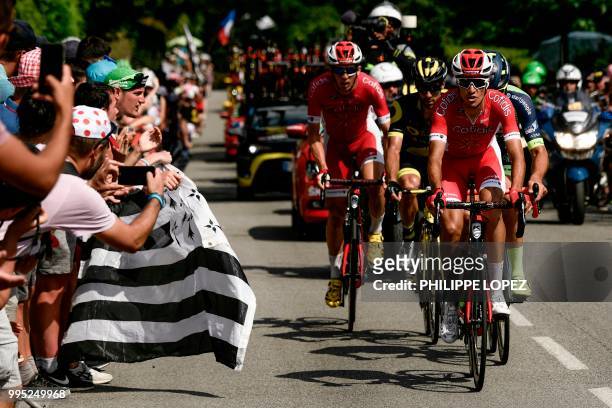 Spectators cheer waving the flag of Brittany as France's Anthony Perez , France's Jerome Cousin , Belgium's Guillaume Van Keirsbulck and Belgium's...