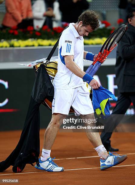 Andy Murray of Great Britain shows his dejection as he walks off the court after a straight sets defeat by David Ferrer of Spain in their quarter...