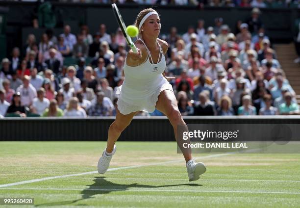 Italy's Camila Giorgi returns against US player Serena Williams during their women's singles quarter-final match on the eighth day of the 2018...