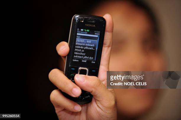 Philippine woman shows her composed mobile phone text message in a cyber dialect called 'jejemon' in Manila on June 10, 2010. The Philippines is...