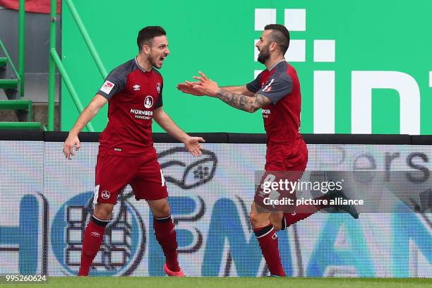 Nuremberg's Mikael Ishak cheers over his 0-1 score with team mate Kevin Moehwald during the German 2. Bundesliga match between SpVgg Greuther Fuerth...