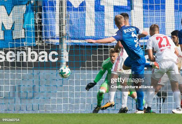 Bochum's Bochum's Felix Bastians scores 1-0 against Ingolstadt's goalkeeper Orjan Nyland and Tobias Schroeck during the German 2. Bundesliga match...