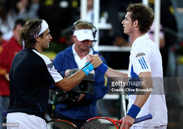 Andy Murray of Great Britain shows his dejection as he shakes hands at the net after a straight sets defeat by David Ferrer of Spain in their quarter...
