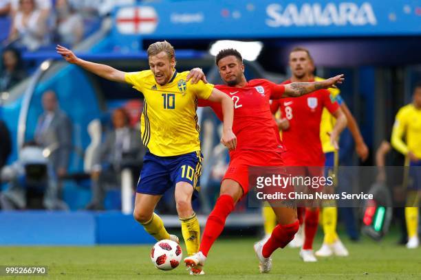 Emil Forsberg of Sweden and Kyle Walker of England vie for the ball during the 2018 FIFA World Cup Russia Quarter Final match between Sweden and...