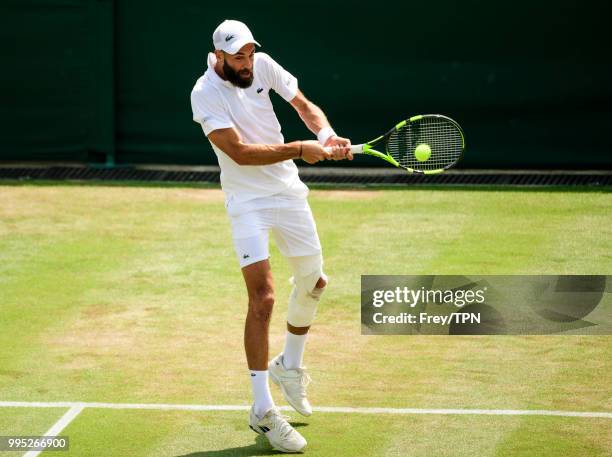 Benoit Paire of France in action against Juan Martin Del Potro of Argentina in the third round of the gentleman's singles at the All England Lawn...