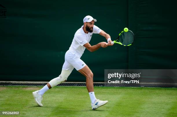 Benoit Paire of France in action against Juan Martin Del Potro of Argentina in the third round of the gentleman's singles at the All England Lawn...