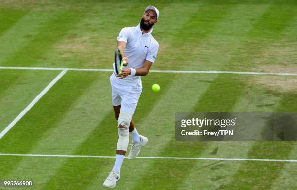 Benoit Paire of France in action against Juan Martin Del Potro of Argentina in the third round of the gentleman's singles at the All England Lawn...