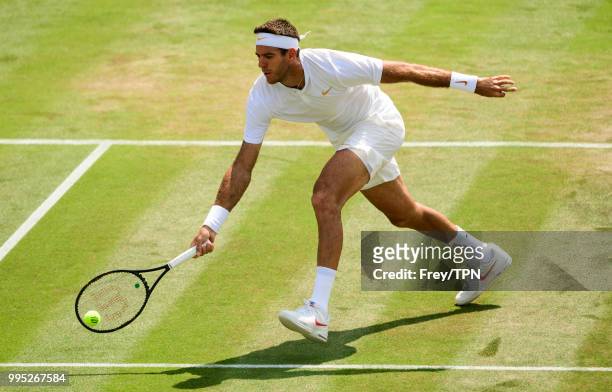 Juan Martin Del Potro of Argentina in action against Benoit Paire of France in the third round of the gentleman's singles at the All England Lawn...