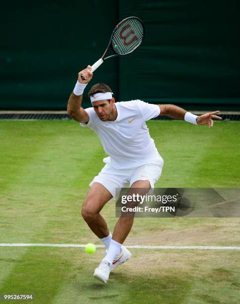 Juan Martin Del Potro of Argentina in action against Benoit Paire of France in the third round of the gentleman's singles at the All England Lawn...