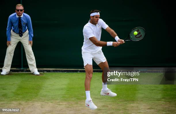 Juan Martin Del Potro of Argentina in action against Benoit Paire of France in the third round of the gentleman's singles at the All England Lawn...