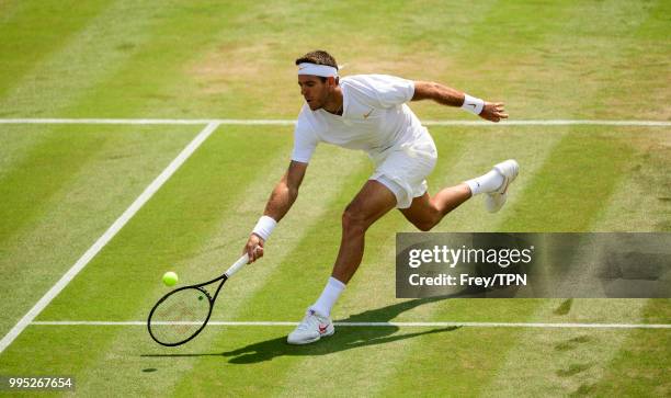 Juan Martin Del Potro of Argentina in action against Benoit Paire of France in the third round of the gentleman's singles at the All England Lawn...