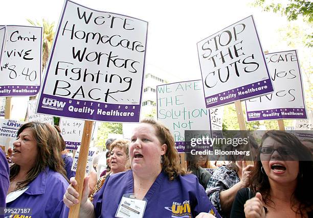 Kaiser Permanente Medical Care workers Elaine Barajas, from left, Nancy Stengel and Xochiti Velasca protest proposed cuts for home care workers,...