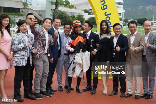 Jockey Joao Moreira, trainer Dennis Yip Chor-hong and owners celebrate after Winning Controller winning Race 7 Tsam Chuk Wan Handicap at Sha Tin...