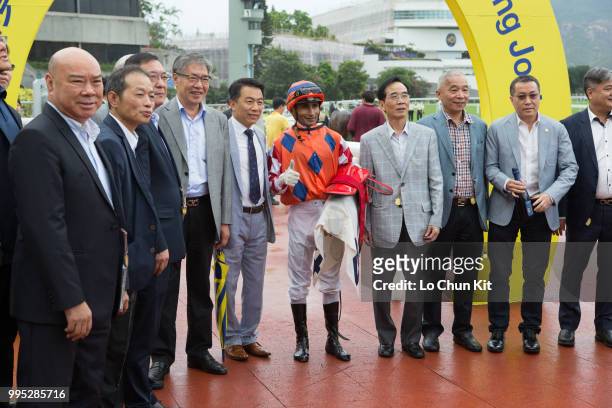 Jockey Karis Teetan, trainer Ricky Yiu Poon-fai and owners celebrate after Encore Boy winning Race 8 Lai Chi Chong Handicap at Sha Tin racecourse on...