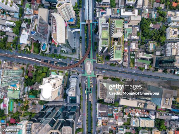 top view of city road junctions in heart of business center on sathorn and silom district at bangkok city thailand. aerial view of bts skytrain run into the smart city at bangkok downtown in thailand. - heart cross section stock pictures, royalty-free photos & images