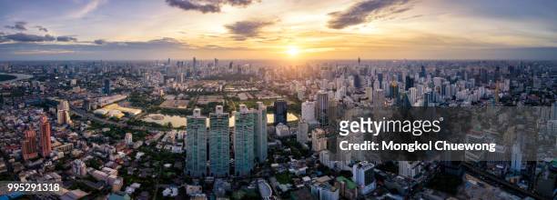 aerial view of bangkok skyline and skyscraper on sukhumvit center of business in capital. panorama of modern city and bts skytrain with benjakiti park on asoke junction at bangkok thailand on sunset - bts bangkok stock pictures, royalty-free photos & images