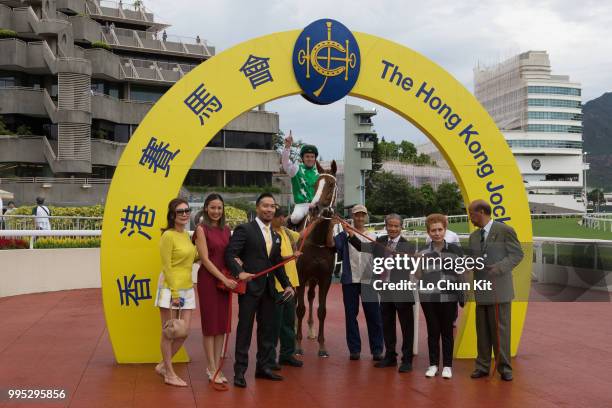 Jockey Tommy Berry, owner Kerm Din and trainer Tony Cruz celebrate after Pakistan Friend winning Race 9 Tai Mong Tsai Handicap at Sha Tin racecourse...