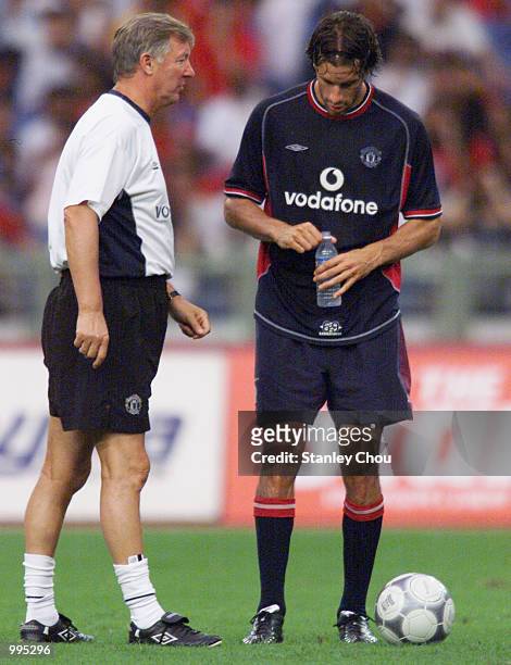 Ruud Van Nistelrooy of Manchester United takes his instructions from his manager, Alex Ferguson during an evening training session held at the Bukit...