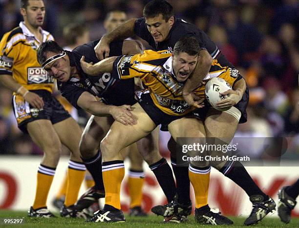 Luke O''Donnell of the Tigers is tackled by Craig Greenhill of the Panthers during the round 25 NRL match between the Penrith Panthers and the Wests...