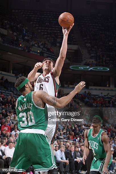 Andrew Bogut of the Milwaukee Bucks puts the ball up against Rasheed Wallace of the Boston Celtics on March 9, 2010 at the Bradley Center in...