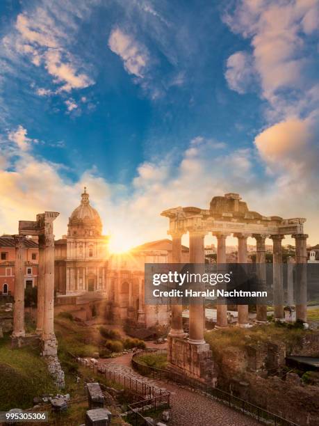 temple of vespasian and titus and church of santi luca e martina at forum romanum at sunrise, rome, lazio, italy - arch of titus fotografías e imágenes de stock