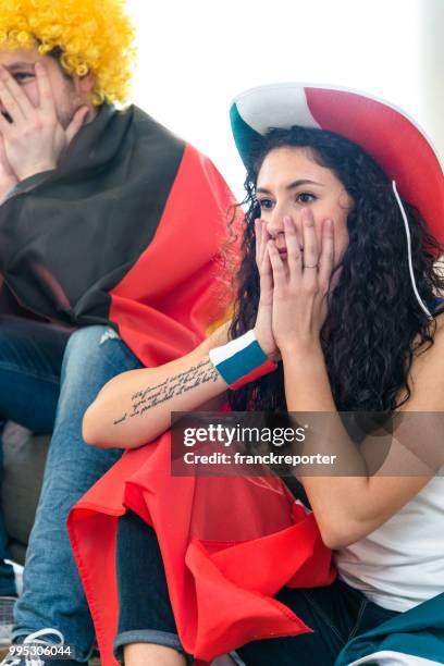 sad france supporter in front of the tv - distress flag stock pictures, royalty-free photos & images