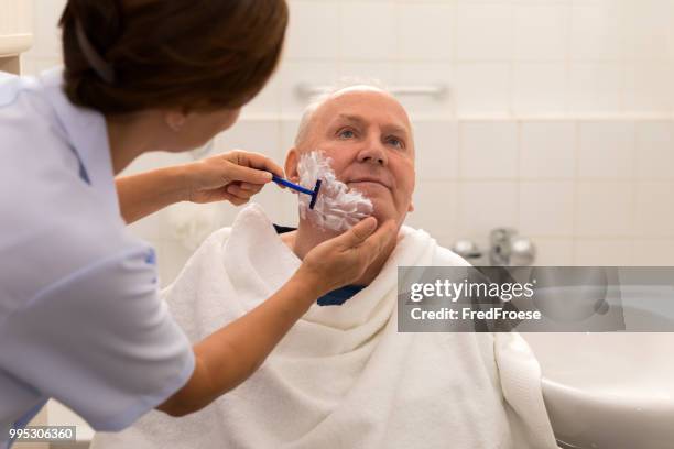 personal hygiene – home caregiver with senior man in bathroom - personal care stock pictures, royalty-free photos & images