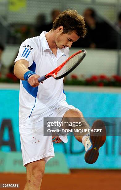 British Andy Murray looks at this shirt during his match against Spanish David Ferrer during the Madrid Masters tennis on May 14, 2010 at the Caja...