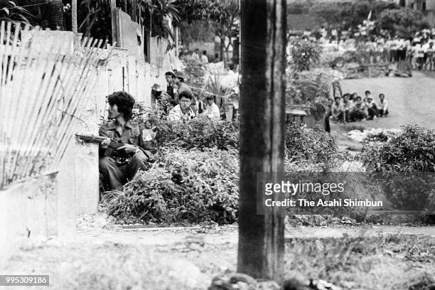 Pro-Aquino soldiers exchange fire with pro-Marcos government soldiers at the government-owned Channel 4 broadcasting complex on February 25, 1986 in...