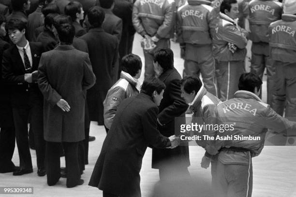 Delegates from North and South Korea shake hands at the closing ceremony of the 1st Asian Winter Games at Makomanai Indoor Stadium on March 8, 1986...