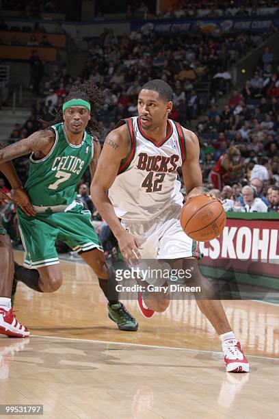 Charlie Bell of the Milwaukee Bucks drives the ball against Marquis Daniels of the Boston Celtics on March 9, 2010 at the Bradley Center in...