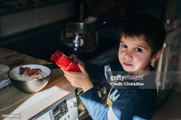 cute little boy with a helping to cook - click&boo bildbanksfoton och bilder