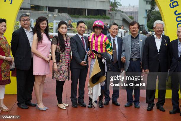 Jockey Vincent Ho Chak-yiu, trainer Francis Lui Kin-wai and owner celebrate after winning Race 11 Pak Sha O Handicap at Sha Tin racecourse on July 8...