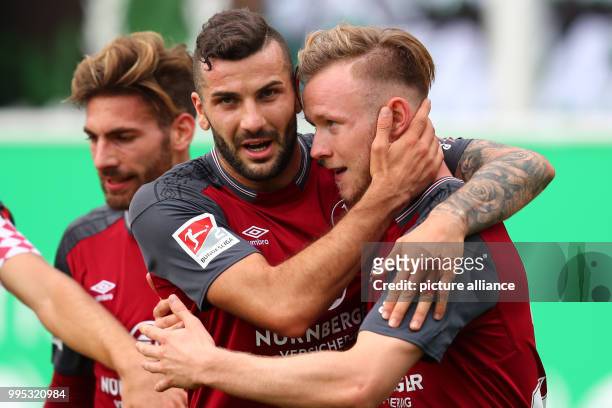 Nuremberg's Cedric Teuchert and Mikael Ishak cheer over the 0-2 score during the German 2. Bundesliga match between SpVgg Greuther Fuerth and 1. FC...