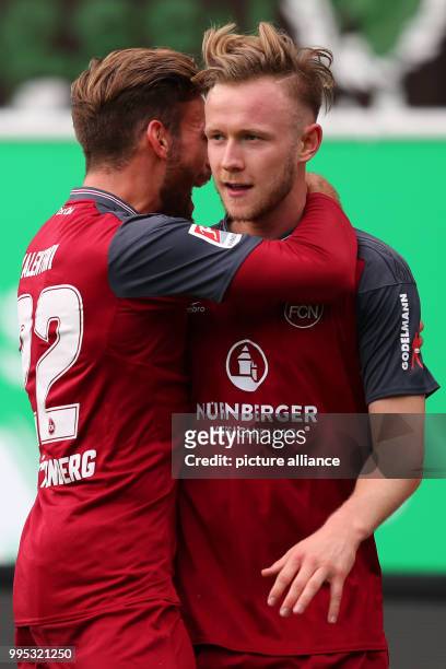 Nuremberg's Cedric Teuchert and Enrico Valentini cheer over the 0-2 score during the German 2. Bundesliga match between SpVgg Greuther Fuerth and 1....