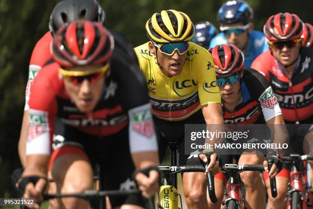 Belgium's Greg Van Avermaet, wearing the overall leader's yellow jersey , rides in the pack with his USA's BMC Racing cycling team teammates during...