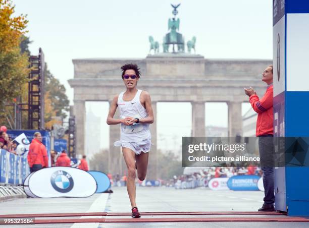 Japanese runner Hiroaki Sano places 7th during the 44th Berlin Marathon in Berlin, Germany, 24 September 2017. On the right is Berlin's mayor Michael...