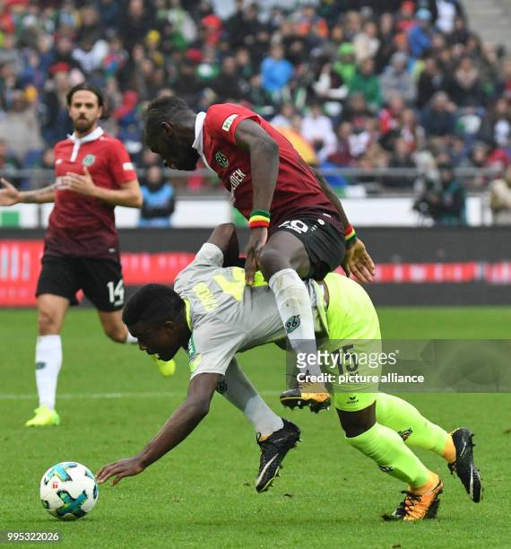 Hanover's Salif Sane plays against Cologne's Jhon Cordoba during the German Bundesliga match between Hanover 96 and 1. FC Cologne at the HDI Arena in...