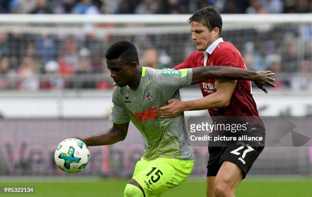 Hanover's Pirmin Schwegler and Cologne's Jhon Cordoba vie for the ball during the German Bundesliga match between Hanover 96 and 1. FC Cologne at the...