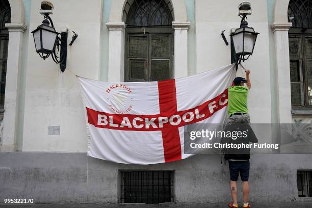 England fans hoist their flag Nikolskaya St near Red Square ahead of the World Cup semi-final game between England and Croatia on July 10, 2018 in...