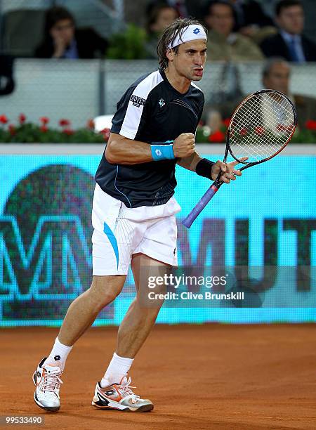 David Ferrer of Spain celebrates on his way to a straight sets victory against Andy Murray of Great Britain in their quarter final match during the...