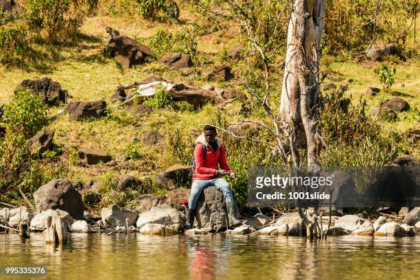 fisherman at lake naivasha, he is fishing - 1001slide stock pictures, royalty-free photos & images