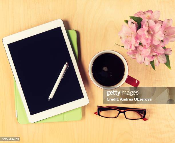 office table with digital tablet, reading glasses and cup of coffee. view from above with copy space - opslagmedia voor analoge audio stockfoto's en -beelden