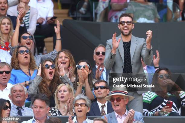 Justin Timberlake applauds a shot played by Serena Williams of the United States during her Ladies' Singles Quarter-Finals match against Camila...