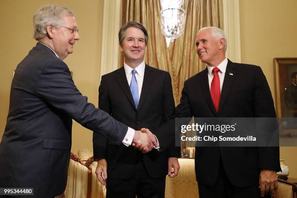 Judge Brett Kavanaugh stands by as Senate Majority Leader Mitch McConnell greets Vice President Mike Pence before a meeting in McConnell's office in...