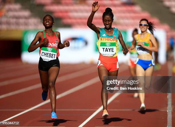 Beatrice Chebet of Kenya crosses the finish line ahead of Ejgayehu Taye of Ethiopia to win the women's 5000m final during day one of The IAAF World...